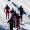 A group of men head to the finish line in a cross country ski race.